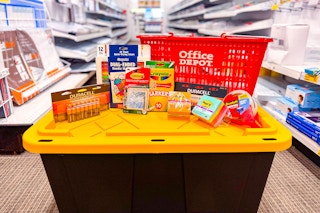 a storage tub with an office depot basket and other products on top