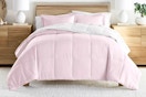 Lifestyle image of the blush/white reversible comforter set from Noble Linens