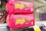 friskies dry cat food stacked on store shelf