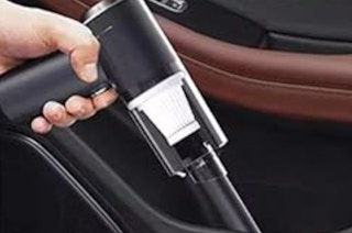 two mini car vacuums cleaning a car