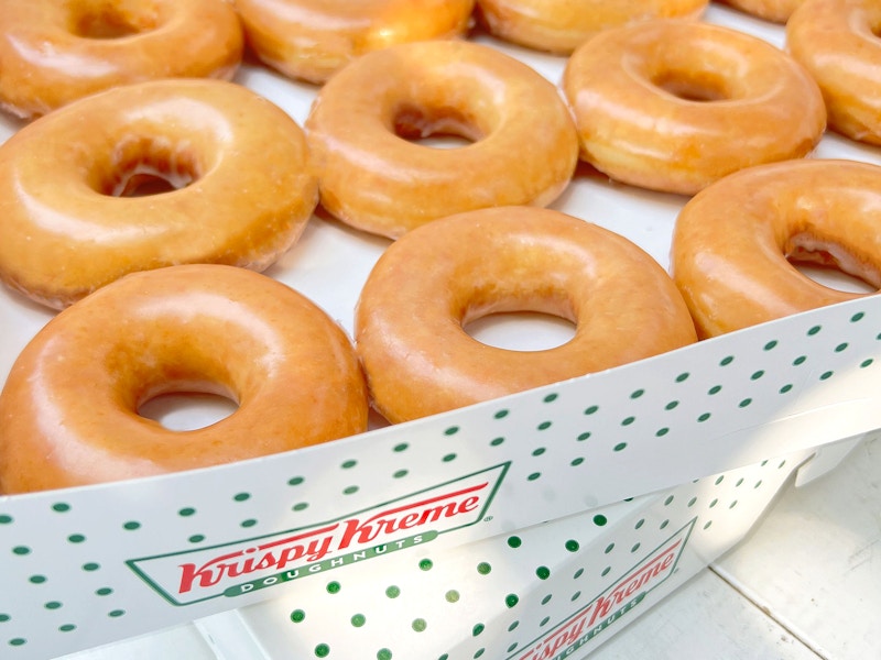 stacked boxes of krispy kreme original glazed doughnuts