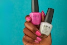 hand holding two OPI nail polishes