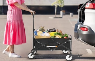 a woman loading groceries into her car from a wagon