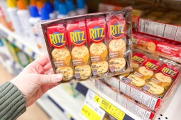 hand holding a box of ritz peanut butter crackers