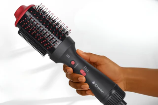 hand holding a hair blowing brush