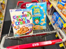 two boxes of General Mills cereal inside cart