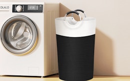 a laundry hamper next to a washing machine