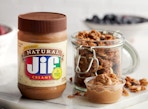 a jar of peanut butter next to jars of food 