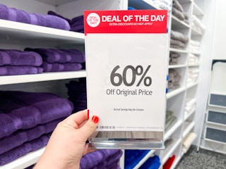 someone holding a macy's one day sale sign