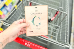 person holding a rael beauty sheet mask over a cart