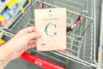 person holding a rael beauty sheet mask over a cart