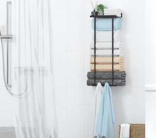 a rack with towel on a bathroom wall