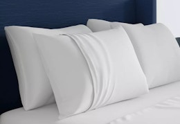 sealy cooling pillow with pillowcase sitting on a bed