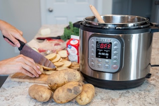 person cutting potatoes near an Instant Pot