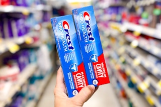 hand holding crest toothpaste