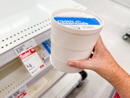 hand holding a swivel bath canister in front of a target shelf