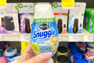 hand holding renuzit cone in front of shelf