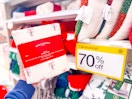 hand holding a holiday sheet set in front of 70% off Target clearance