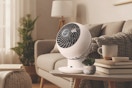 fan set on end table near couch