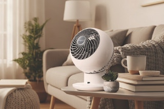 fan set on end table near couch
