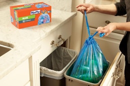 a woman using hefty blue bags