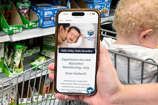 someone holding a phone displaying the my gerber baby website page
