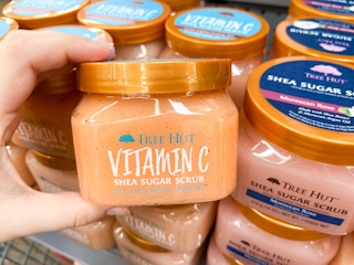 hand holding up tree hut scrub at Walmart