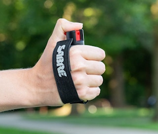a person holding pepper spray