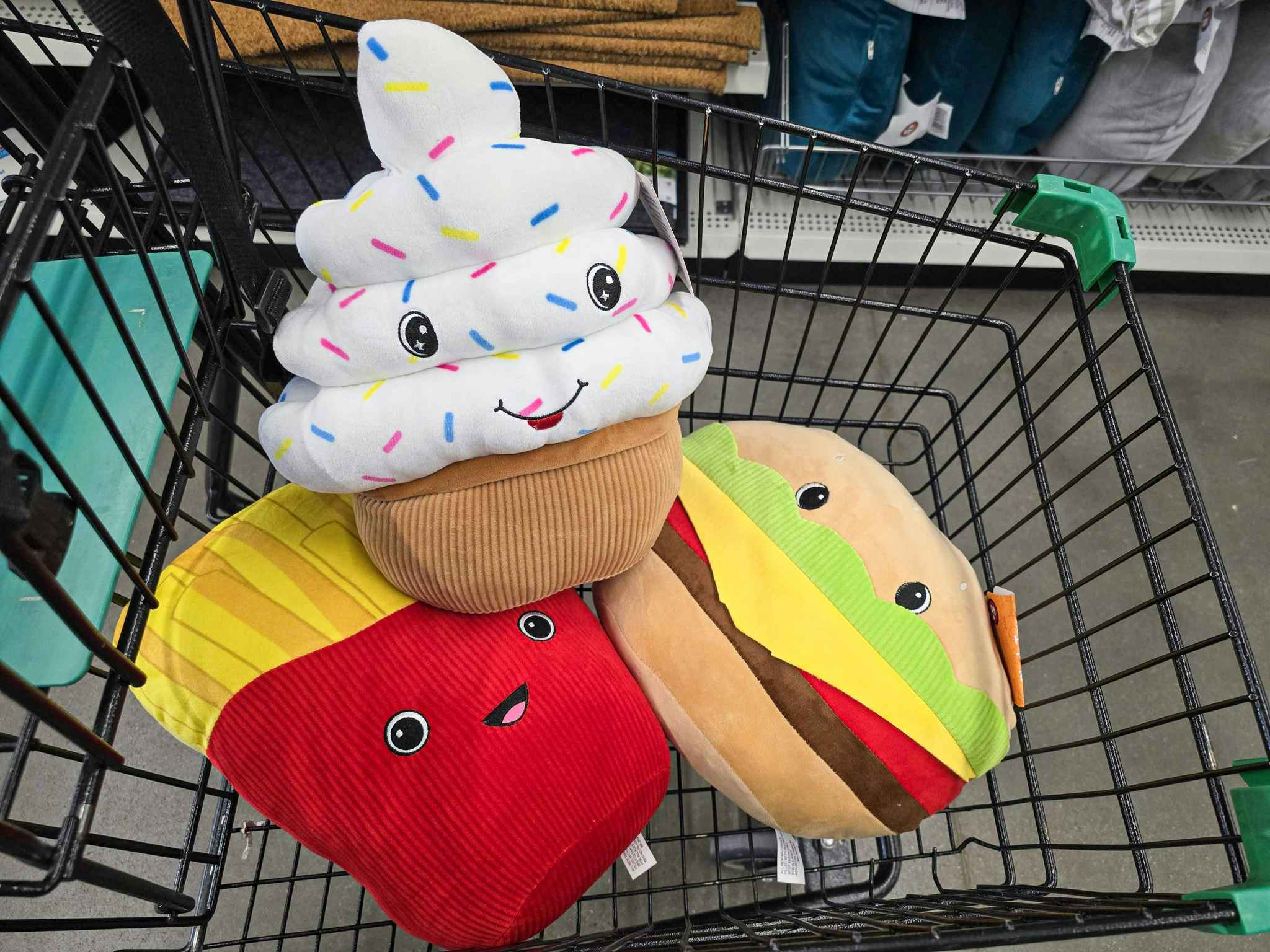 cupcake, french fries, and hamburger plushes in a cart