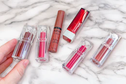 lipsticks and lip gloss on a counter