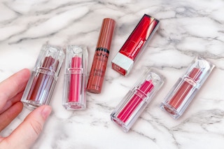 lipsticks and lip gloss on a counter