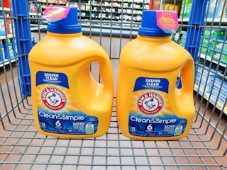 two bottles of arm & hammer clean & simple laundry detergent in walmart cart