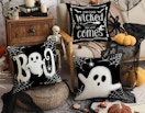 Halloween ghost pillows next to Halloween decorations