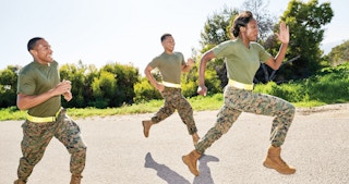 Three people running together in military outfits