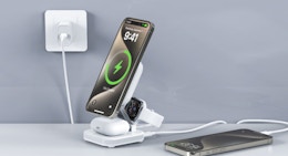 an iPhone, AirPods, and Apple Watch on a charging stand 