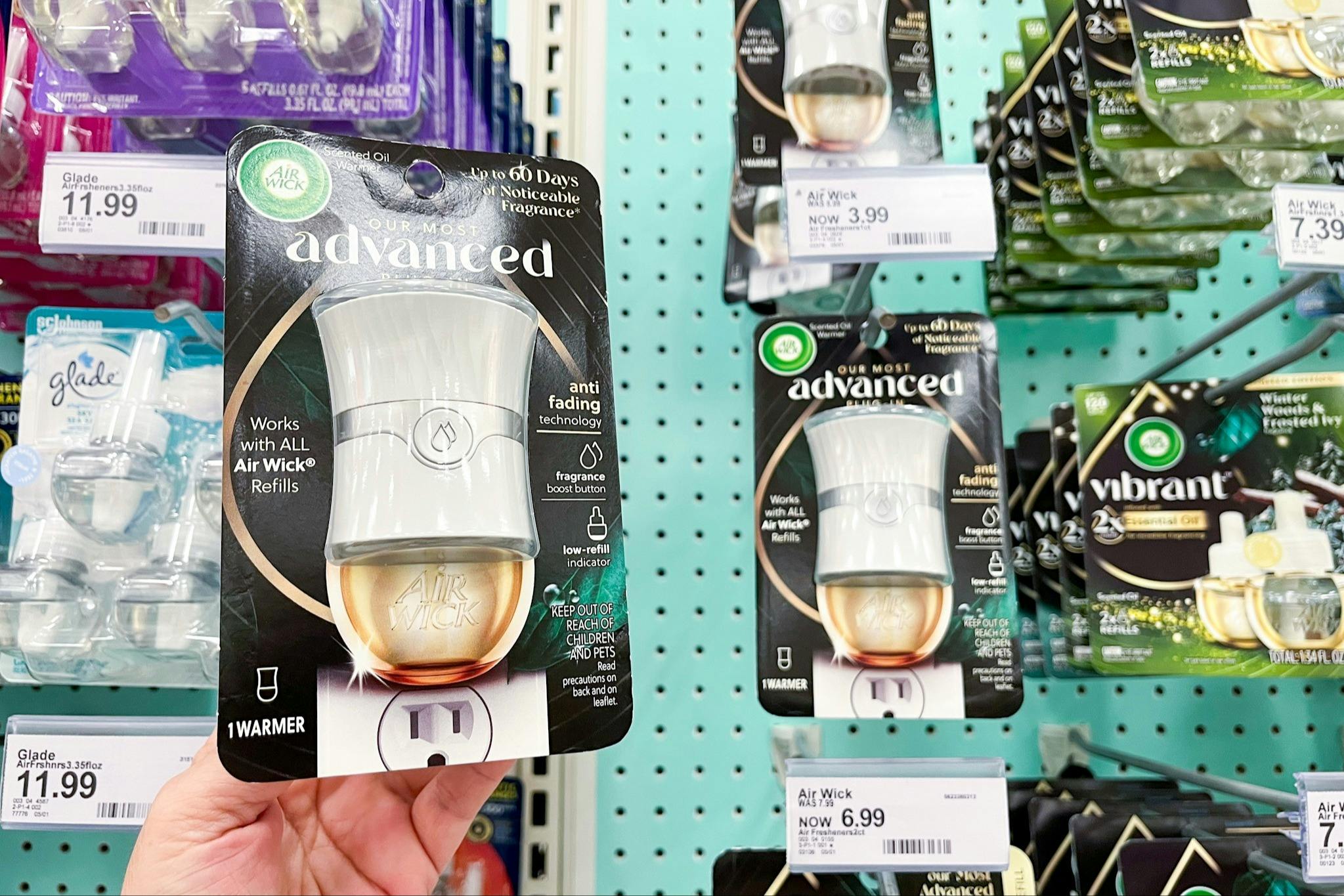 hand holding an air wick warmer in front a target shelf