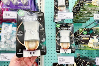 hand holding an air wick warmer in front a target shelf