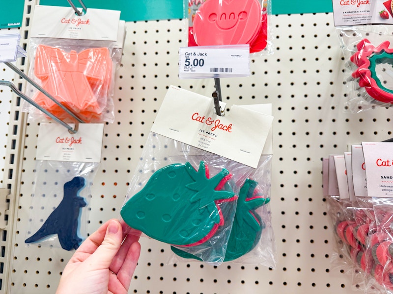 hand holding cat & jack ice packs on wall hook at target