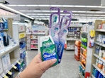 hand holding crest and oral-b products in walgreens 