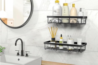 two shelf organizers on a bathroom wall next to a sink 