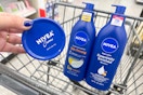hand holding nivea body lotion next to two bottles of nivea lotion