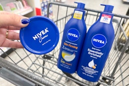 hand holding nivea body lotion next to two bottles of nivea lotion