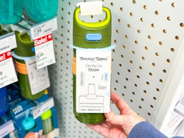 hand holding a tommee tippee straw bottle at target