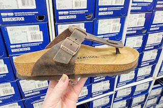 hand holding a birkenstock sandal