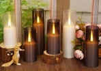 brown and white flameless candles on a table