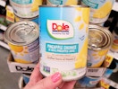 hand holding can of dole pineapple