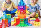 children playing with a magnetic tile set