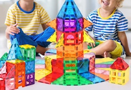 children playing with a magnetic tile set