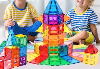 children playing with a magnetic tile set