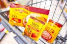 old el paso taco dinner kit, seasoning mix, and refried beans in a cart